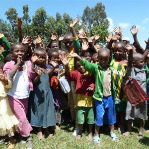 Many Ethiopian children waving and smiling