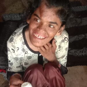 young girl sitting on floor, smiling
