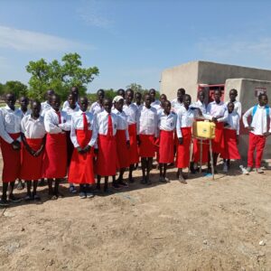 group of girls in school uniform outside the new latrines
